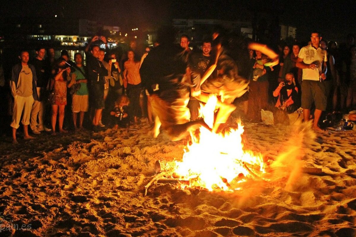 people jumping over the fires in Ibiza
