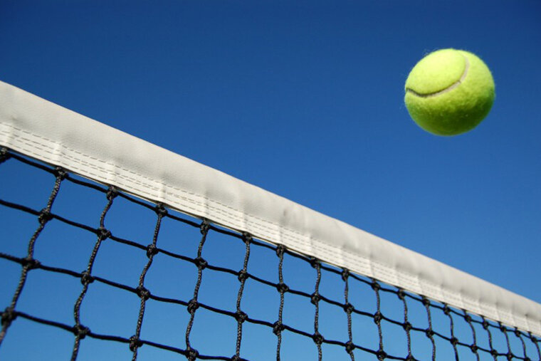 blue skies & tennis ball crossing a net