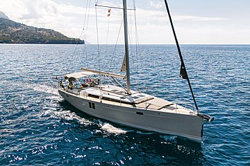 A sailboat is floating on top of a body of water