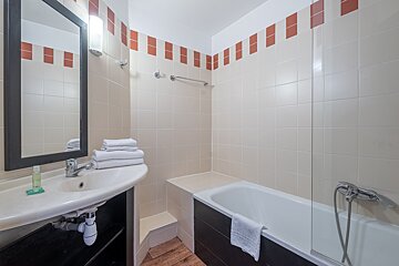 A bathroom with a sink and a bathtub