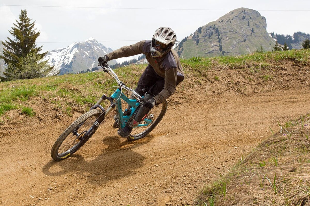 a picture of a woman on a downhill mountain bike trail