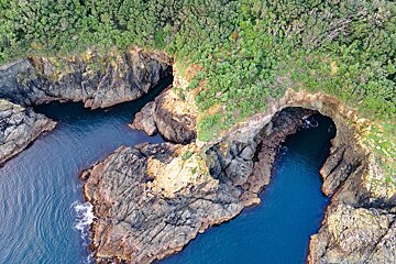 An aerial view of a cliff overlooking a body of water