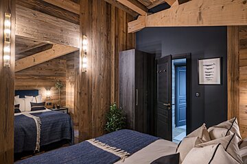 A bedroom with two beds and a picture of fish on the wall