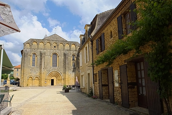 a church in a square of the village of cadouin dordogne
