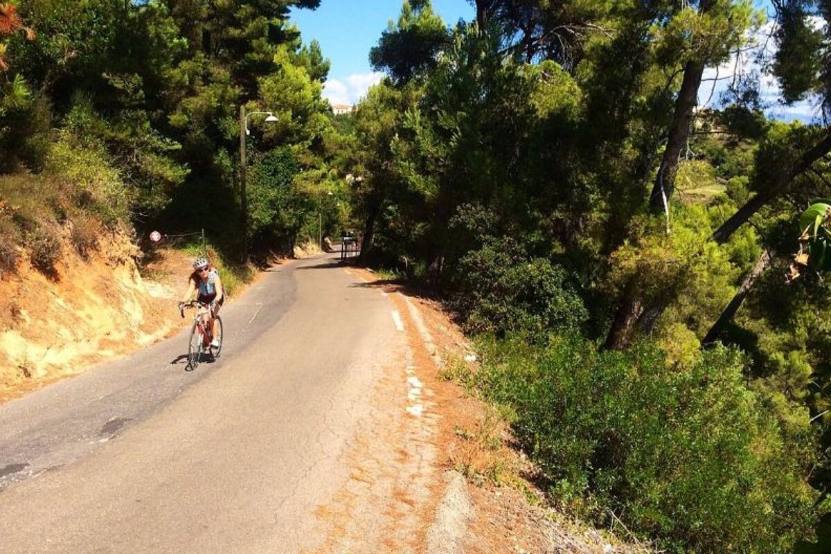 a woman road biking on tarmac in the country
