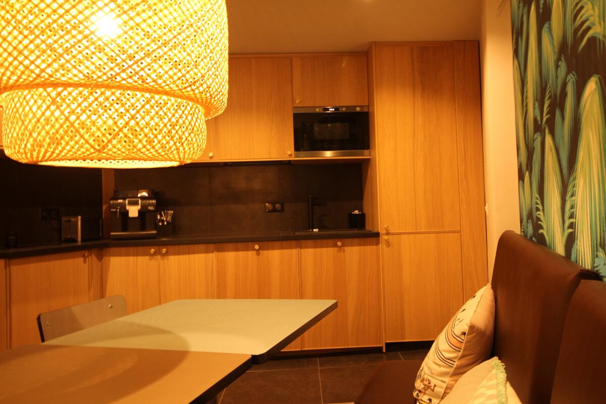 A kitchen with wooden cabinets and a microwave