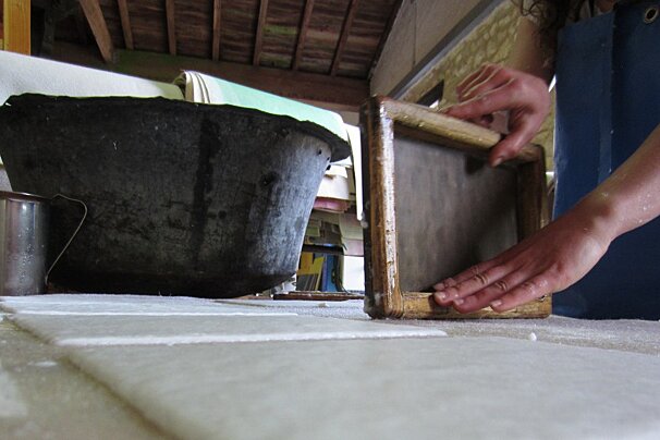 someone making paper by hand in Couse-et-Saint-Front, Dordogne