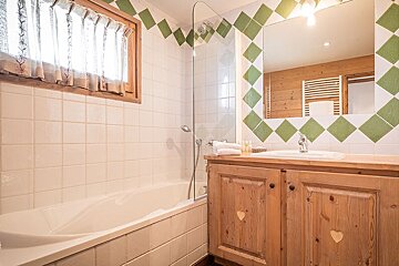 A bathroom with a bathtub and a sink