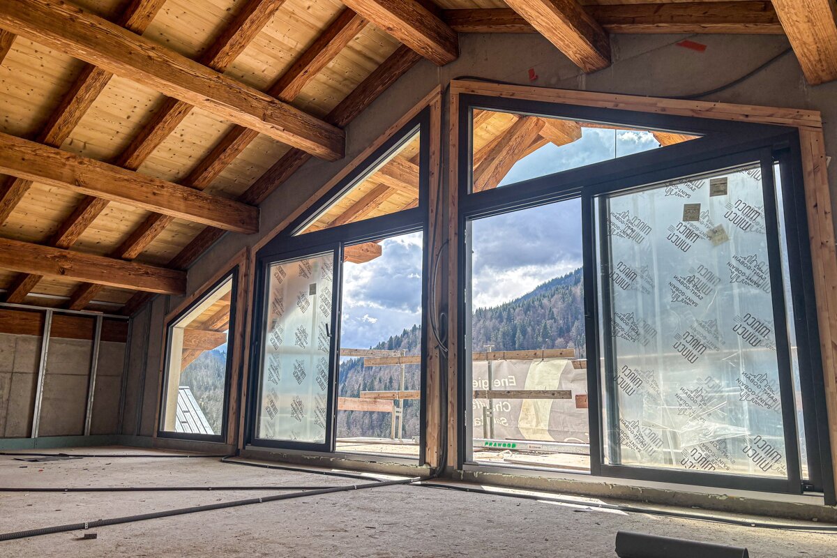 A building under construction with a lot of windows and a roof