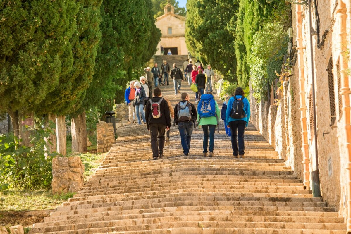 people walking up the calvari steps in pollenca
