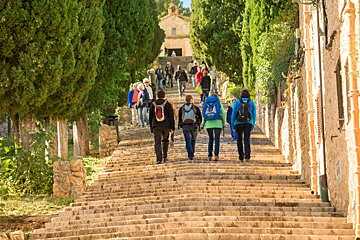 people walking up the calvari steps in pollenca