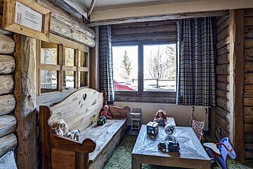 A room with a wooden bench and a table with toys on it