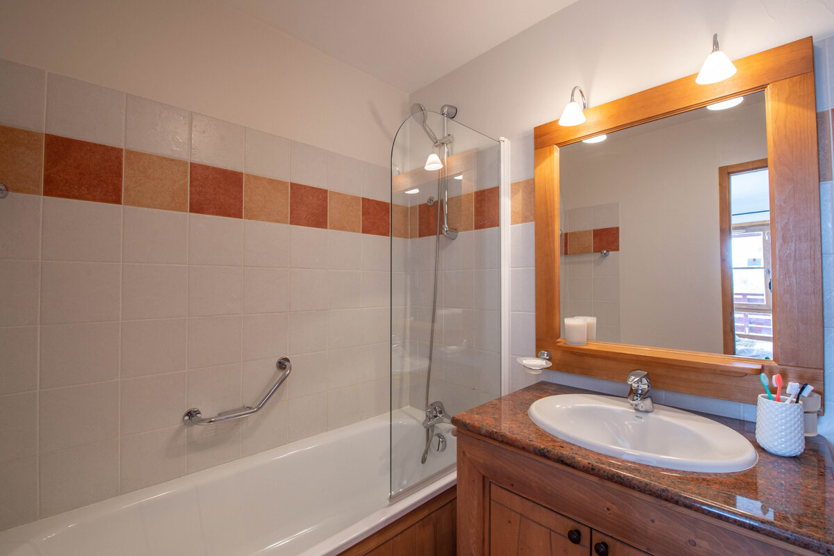 A bathroom with a bathtub and a sink