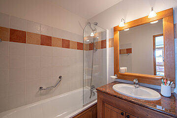 A bathroom with a bathtub and a sink