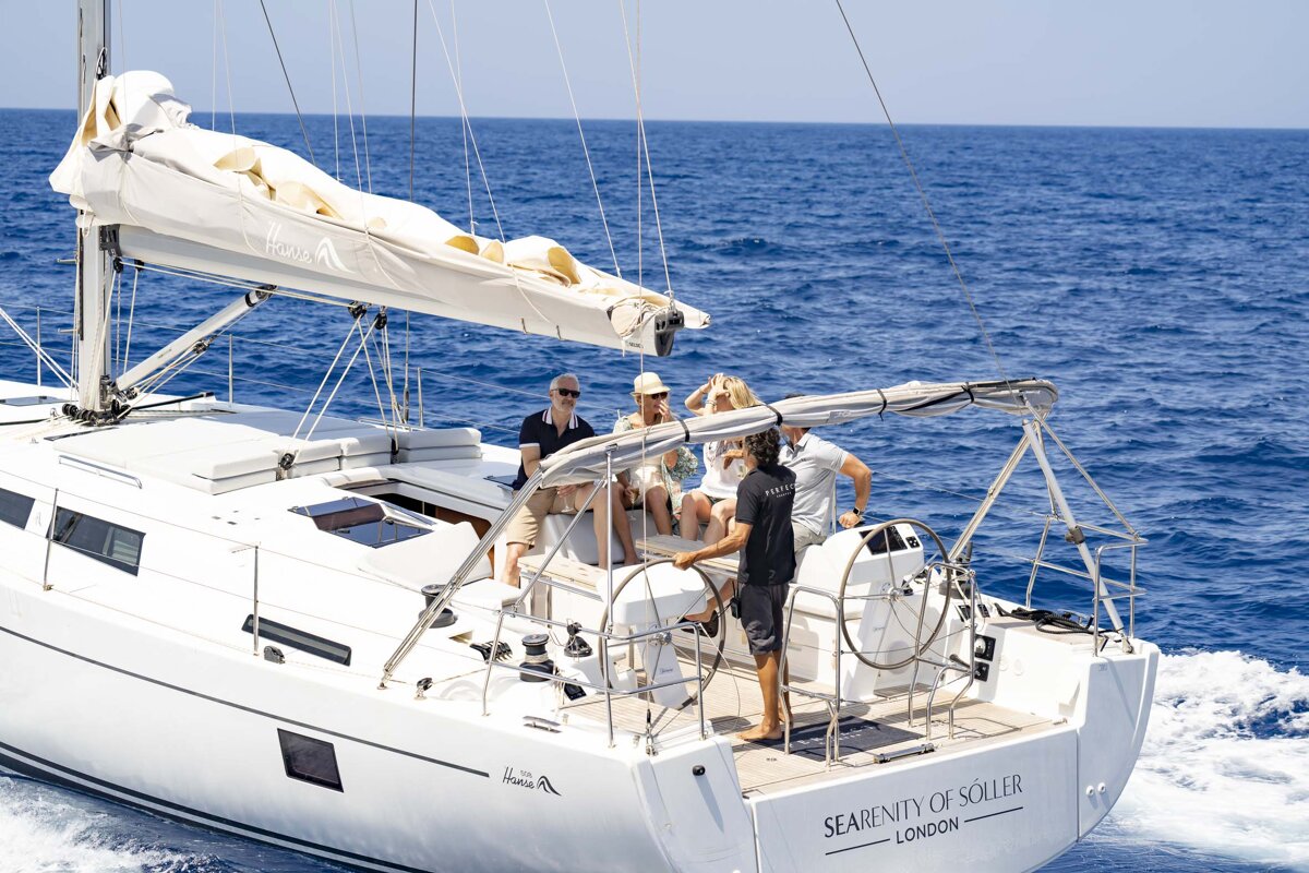 A group of people on a sailboat called serenity of soller