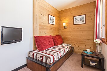 A living room with a couch and a flat screen tv