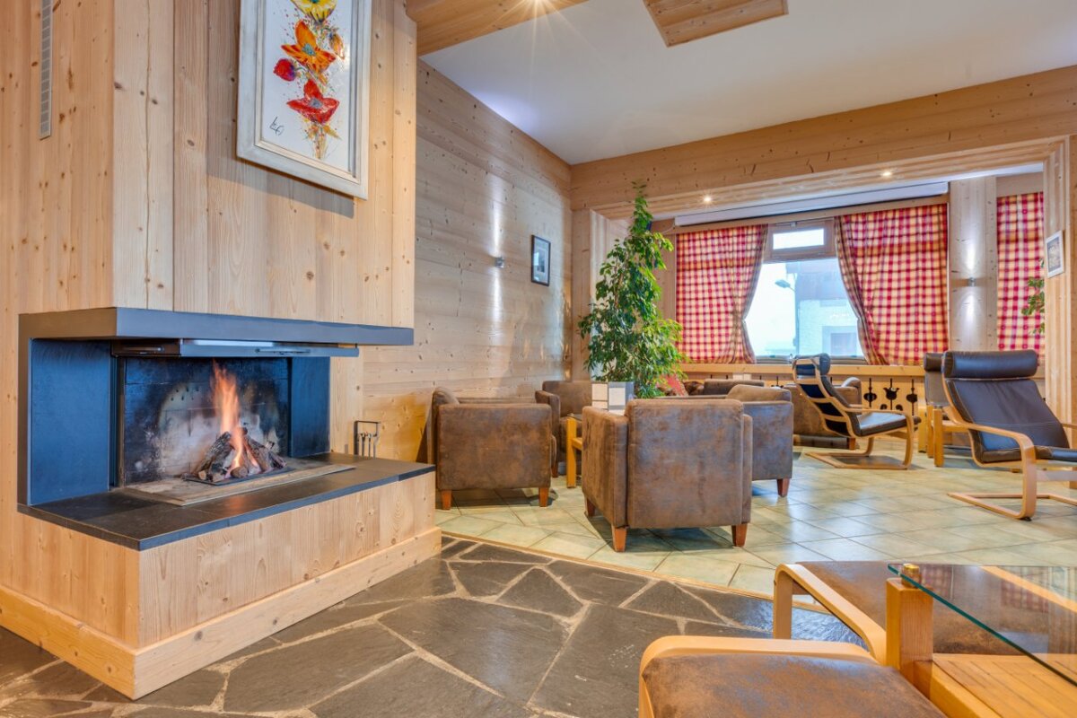 A living room with a fireplace and chairs