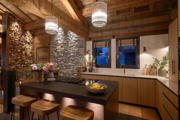 A kitchen with a bowl of lemons on the counter
