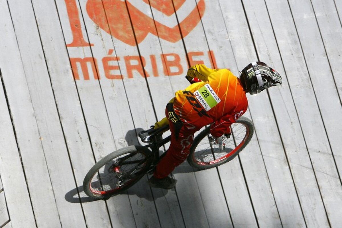 A person riding a bike with the number 28 on their shirt