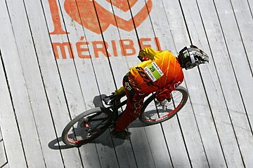 A person riding a bike with the number 28 on their shirt