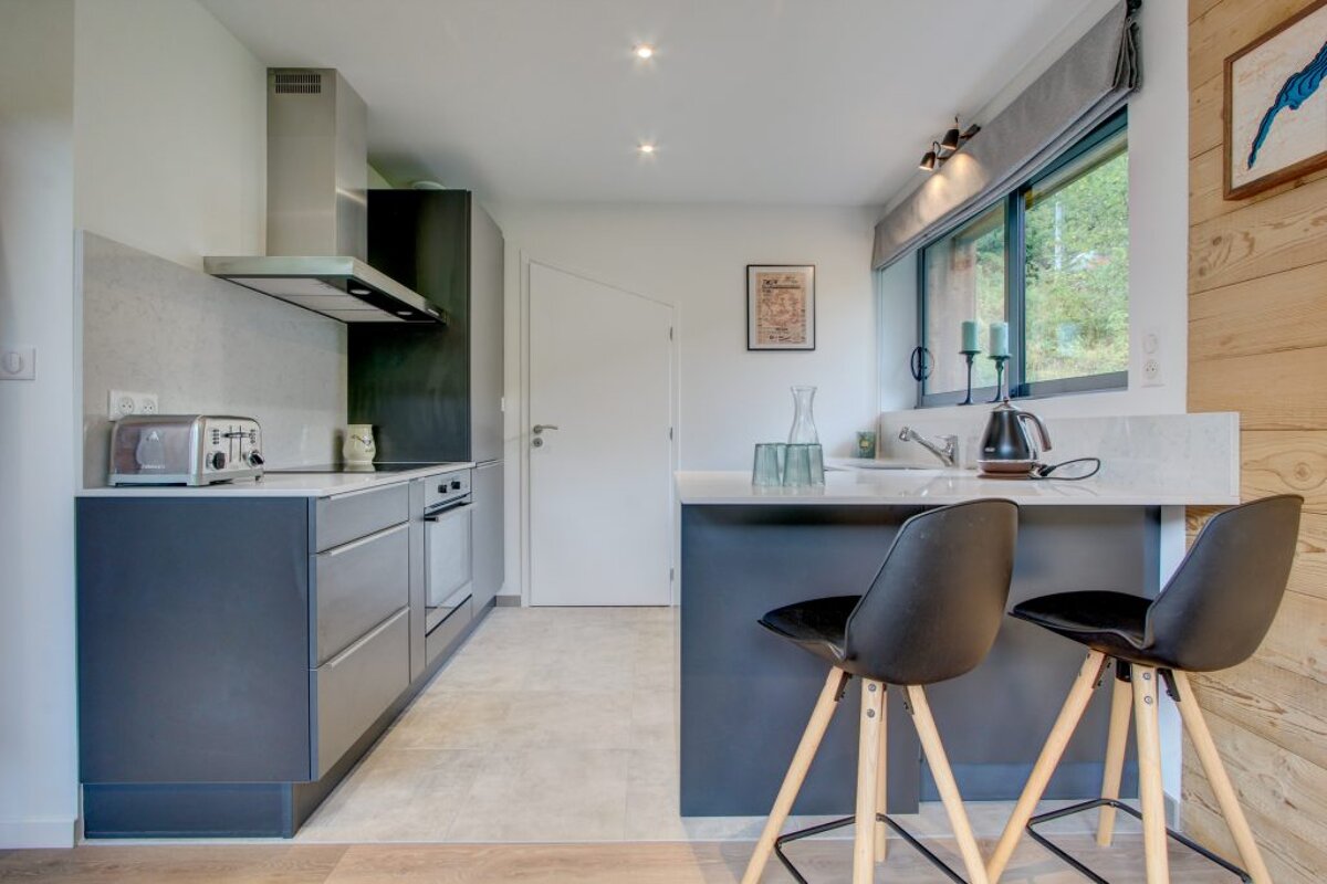 A kitchen with a picture of a bird on the wall
