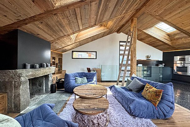 A living room with blue furniture and a fireplace