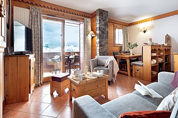 A living room with a couch a chair a table and a television