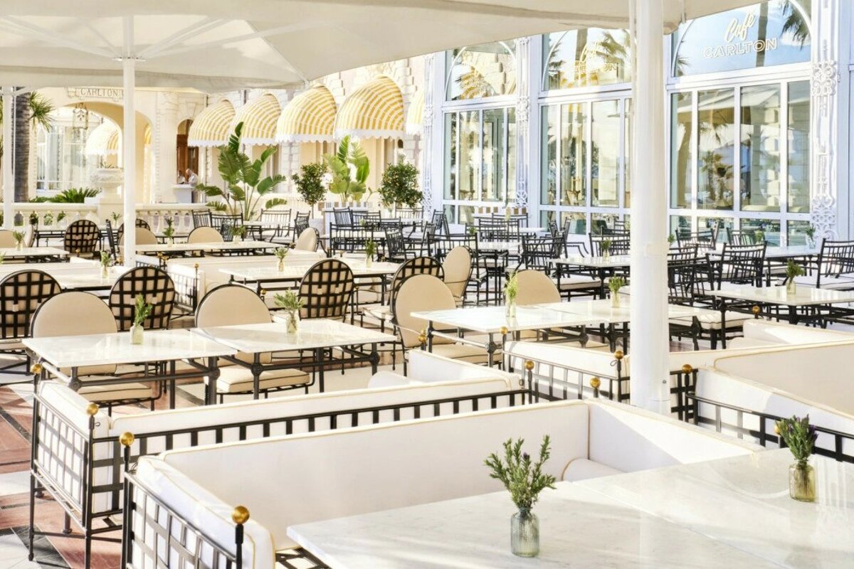 A restaurant with tables and chairs and a sign that says ' a ' on it