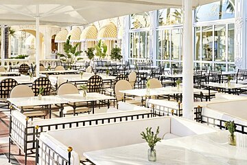 A restaurant with tables and chairs and a sign that says ' a ' on it