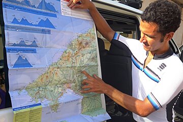 a man in cycling gear looking at a map
