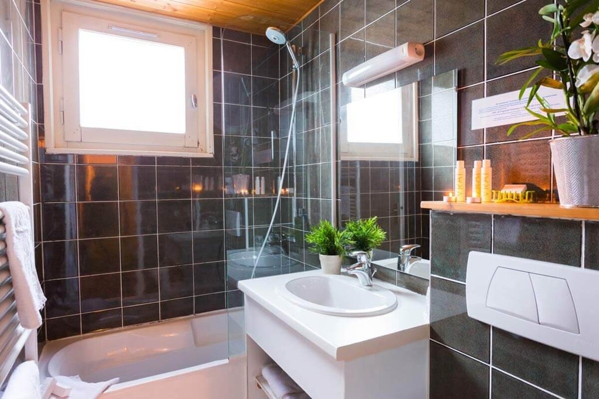 A bathroom with a sink a tub and a mirror