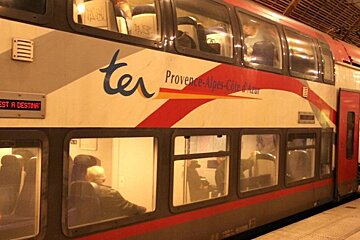 a double decker train at a platform in Antibes