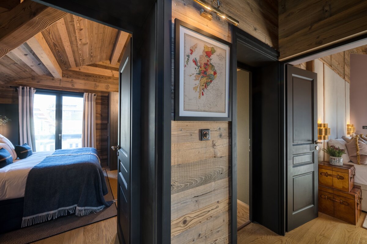 A bedroom with a map on the wall above the door