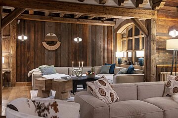 A living room with a couch and a table with candles on it