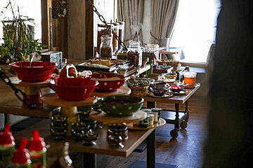 A table with a lot of bowls and jars on it
