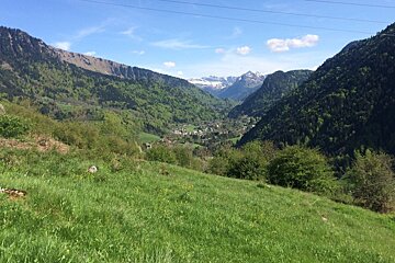 A view of a valley with mountains in the background