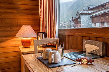 A box of tissues sits on a wooden table