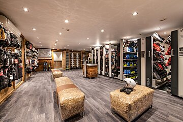 A store with a helmet sitting on a bale of hay