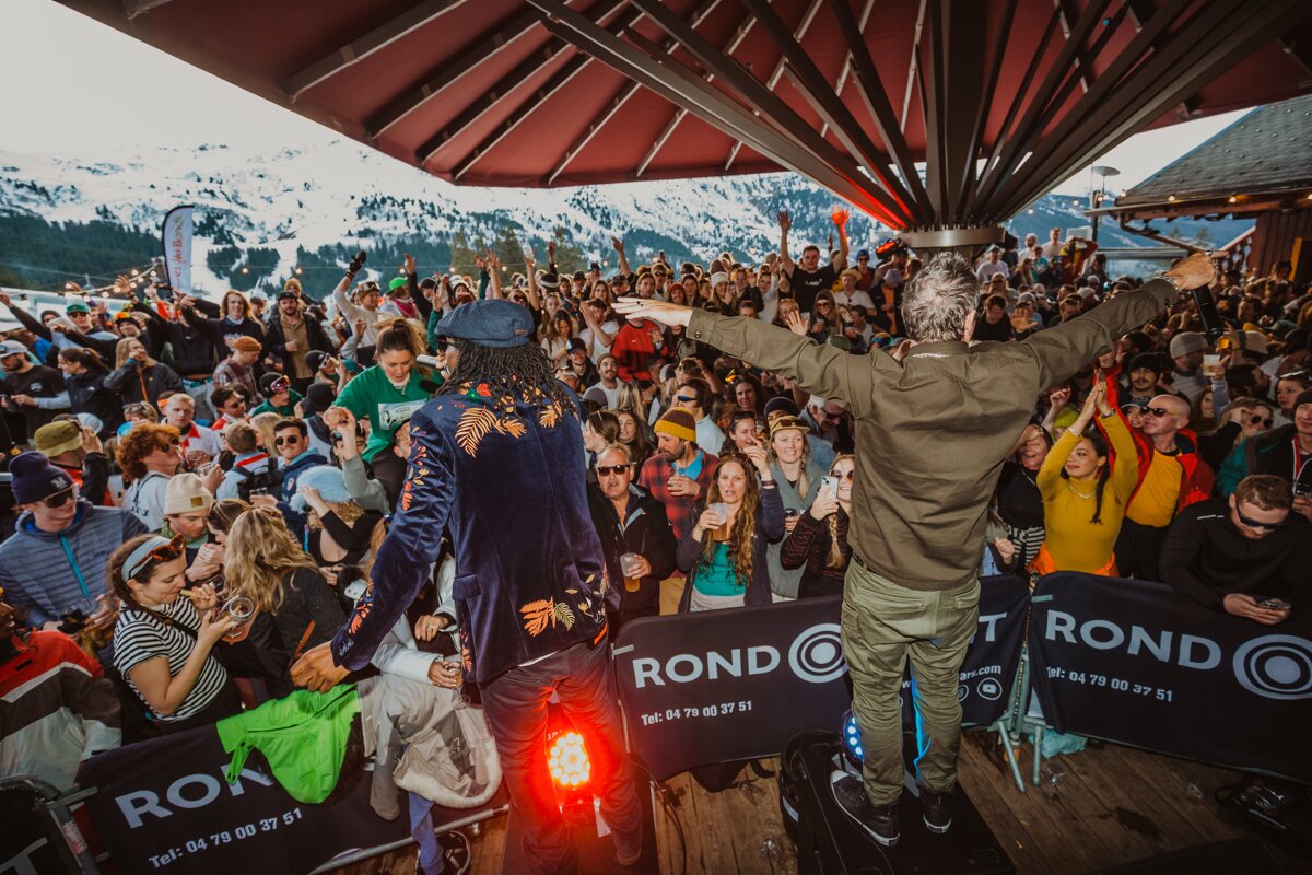 A crowd of people are gathered at a round event