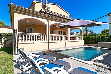 A large house with a swimming pool in front of it