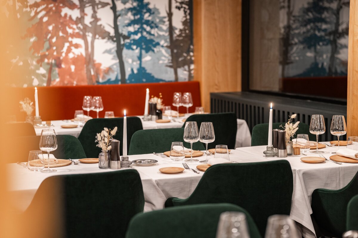 A restaurant with a painting of trees on the wall