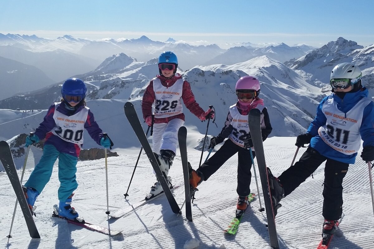 four children on a ski lesson