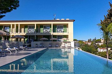 A large building with a swimming pool in front of it