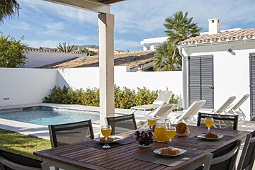 A table with a pitcher of orange juice on it