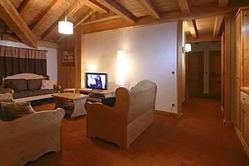 A living room with wooden furniture and a flat screen tv