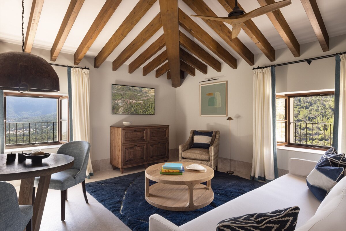 A living room with a couch a chair and a table