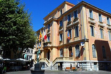 a grand looking building with flags on the walls