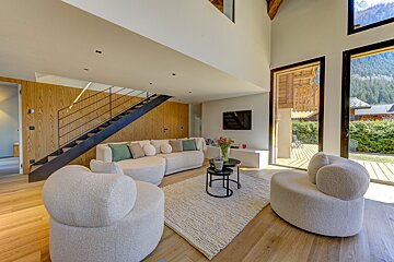 A living room with a staircase leading up to the second floor