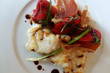 A plate of food with meat and vegetables on it