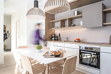 A kitchen with a table and chairs and a coffee maker